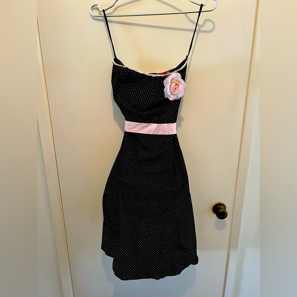 Black Polka Dotted dress with pink belt, tulle, & flower detail.